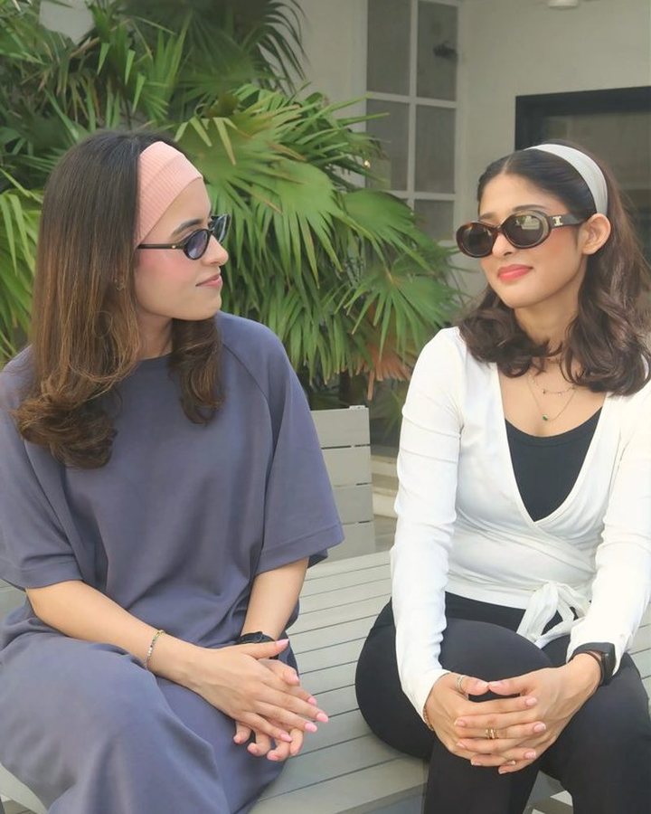 Two members on a garden bench, one in the White Plié Wrap
