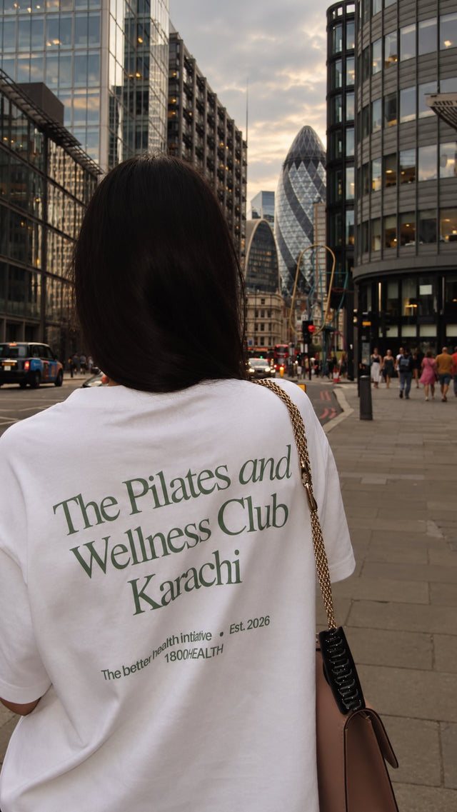 A member from behind in the Club Tee, printed The Pilates and Wellness Club, Karachi, out in the city